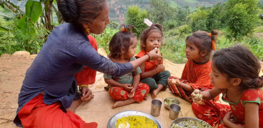 Udisara feeding her children