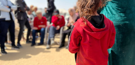 CH11016412 Young girl observes a gathering with Save the Children and people of Rafah Gaza