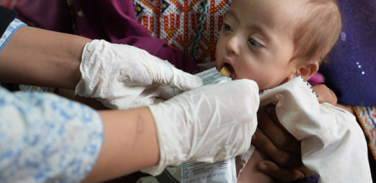 CH11438516 Zia, 8 months, receiving Ready to Use Therapeutic Food (RUTF) at Save the Children Static Health Facility in Southern Afghanistan