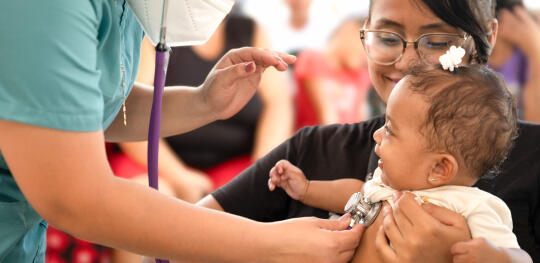 CH11624354 Yennifer (23) brings her child Carmen (4 months) for a health check up at a mobile health clinic