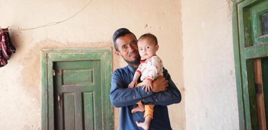CH11629405 Sharif (42) holds Mustafa (9 months) in his arms (1)