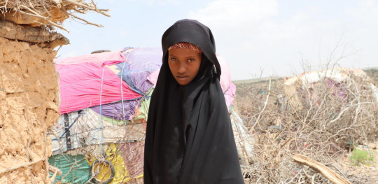 CH1686129 Samia 12 standing in front of where shes currently living with her mother and siblings in an IDP camp in Somalia