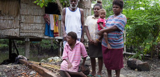 CH1730571 Jemma 17 her mum dad two younger siblings stand outside family home impacted by climate change