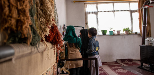 CH1769499 Murtaza as she sews a dress at their home in Afghanistan