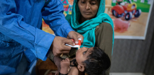CH1778083 Waheed nutrition assistant feeds RUTF to Jaiyana 10 months who received medical help after being diagnosed with Severe Acute Malnutrition at BHU in Khairpur Sindh Pakistan