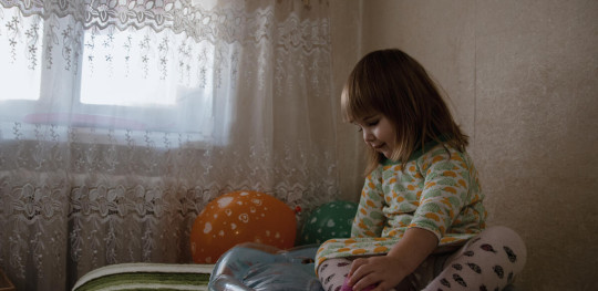 CH1783079 Anastasiia 2 years old sits on a bed in the flat rented by her mother Anna after evacuation from Eastern Ukraine