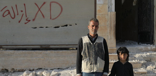 CH1786532 Diaa 51 and his son Mamdouh 8 in front of the building that used to be their house and was destroyed after the earthquake that hit Syria in February 2023