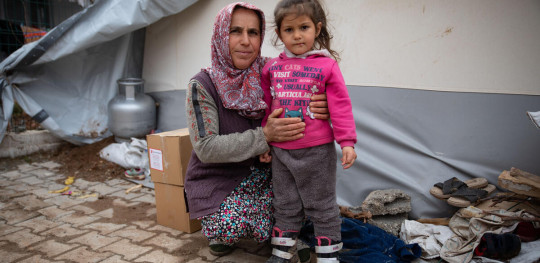 CH1792762 Eylul and her 3 year old granddaughter Fatima outside their tent in a small village in Adyaman Turkiye