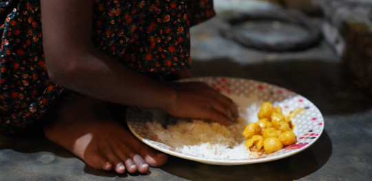 CH1854088 Sultana 7 eats a plate of rice prepared by her mother in Coxs Bazar Bangladesh