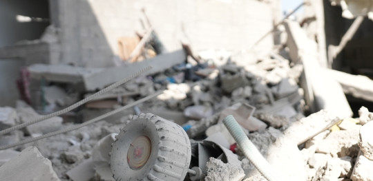 CH1909331 A toy car buried among a rubble in Gaza