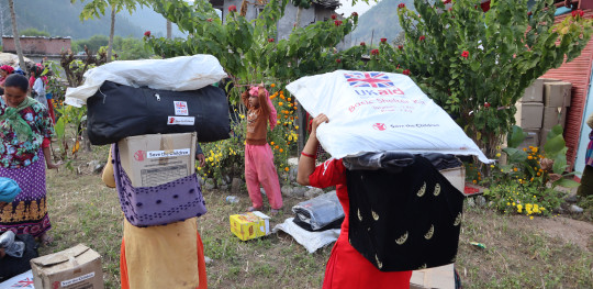 CH1916586 Save the Children Staff in Nepal distributing aid to families affected by Jajarkot earthquake in Karnali Province Nepal