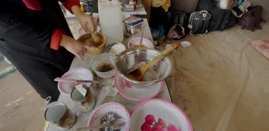 CH1945692 A woman from Faizas family cooking inside the tent where the family lives in a shelter in Al Mawasi Khan Younis southern Gaza