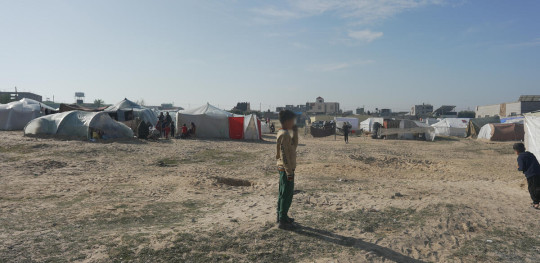 CH1961792 Boy standing in front of tents