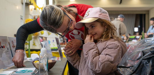 Save the Children Advocacy Director Jacqui Southey shows her granddaughter six year old Scarlett the voting booth