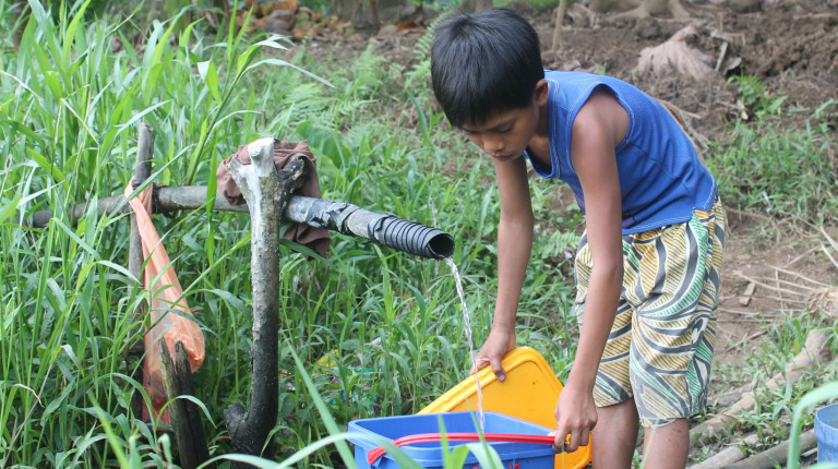 Danilo fetches water from the nearby water source