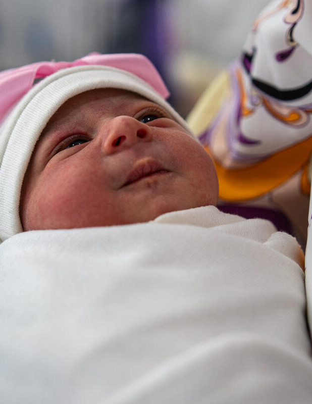CH11035365 Eileen 49 holds her one day old granddaughter Lana at a Save the Children maternity unit Gaza
