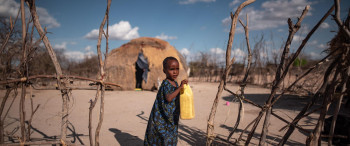 CH1697145 Hafsa 3 drinks from a jerry can outside her home in a drought hit village in Garissa County northern Kenya