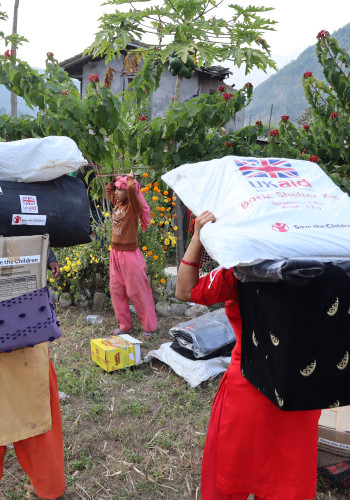 CH1916586 Save the Children Staff in Nepal distributing aid to families affected by Jajarkot earthquake in Karnali Province Nepal v2