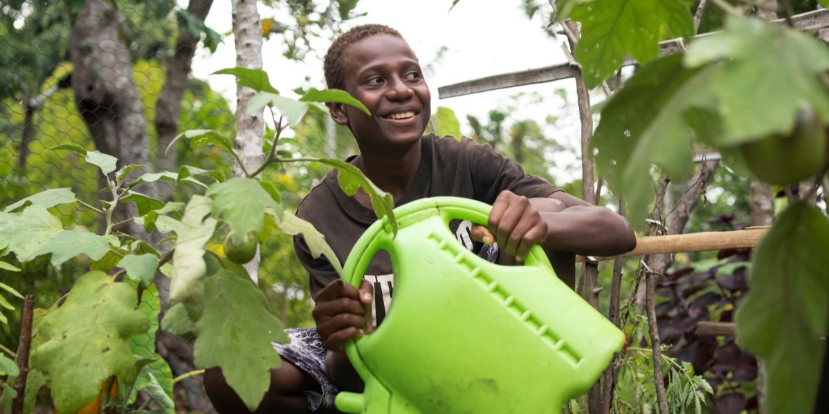CH11209225 Charlie, 14, watering crops in a community nursery on an island in Shefa Province, Vanuatu.