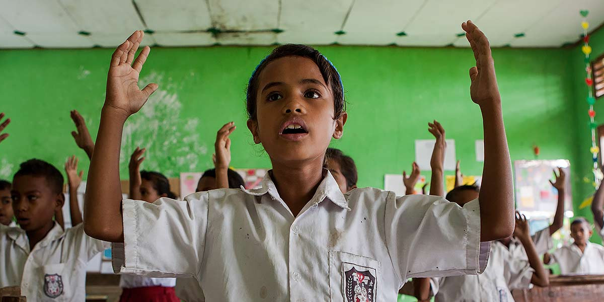 Nurul standing in class room