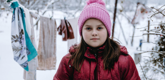 Yulia 9 poses in her yard in Chernihiv region